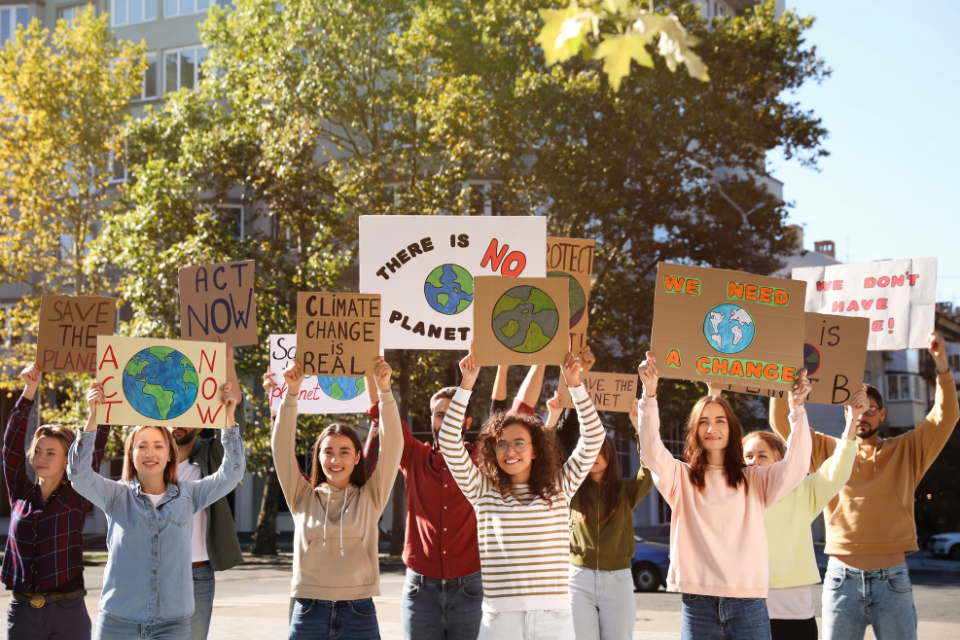 Students with posters stand for climate change action